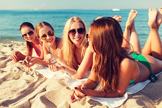 girls on beach wearing sun protection