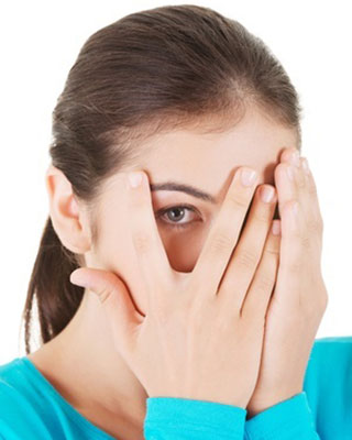 girl with rosacea hiding her face